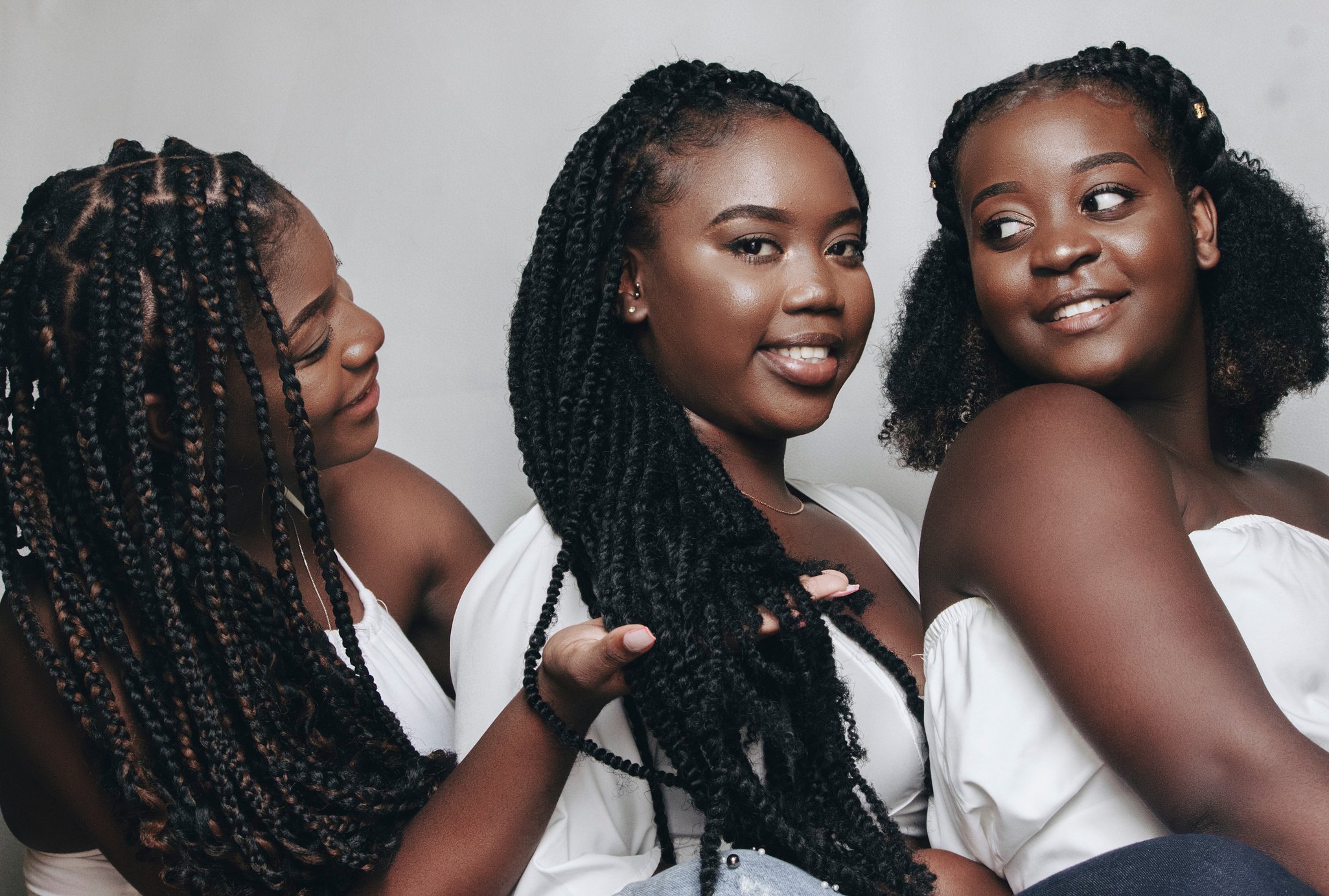 Portrait of Three Smiling Women with Black Hair in Dreadlocks